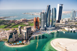 Part of Abu Dhabi, UAE with tall buildings and surrounding area viewed from the helicopter. Many details are visible in the image.